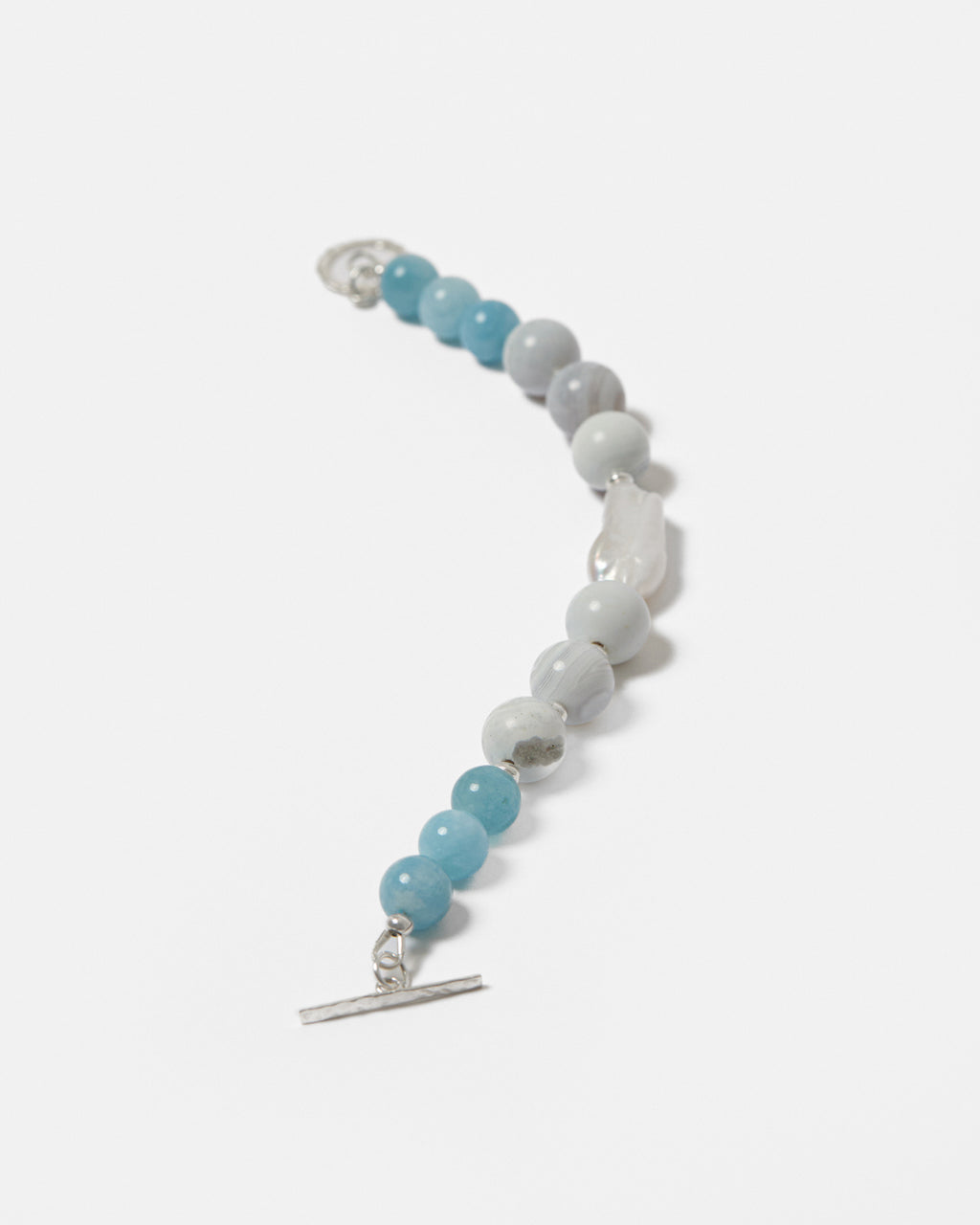 Beaded bracelet with blue and white beads on a white background