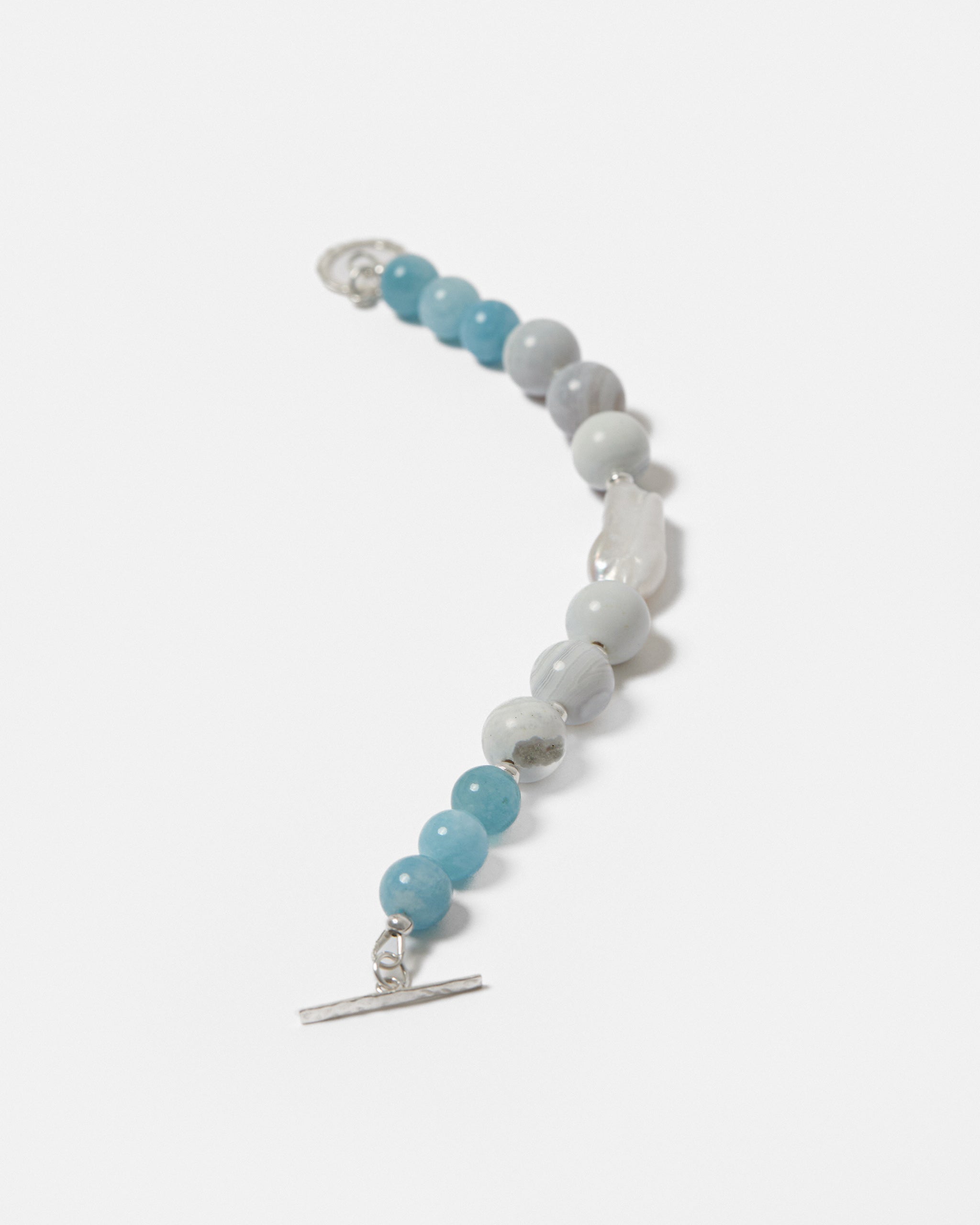 Beaded bracelet with blue and white beads on a white background