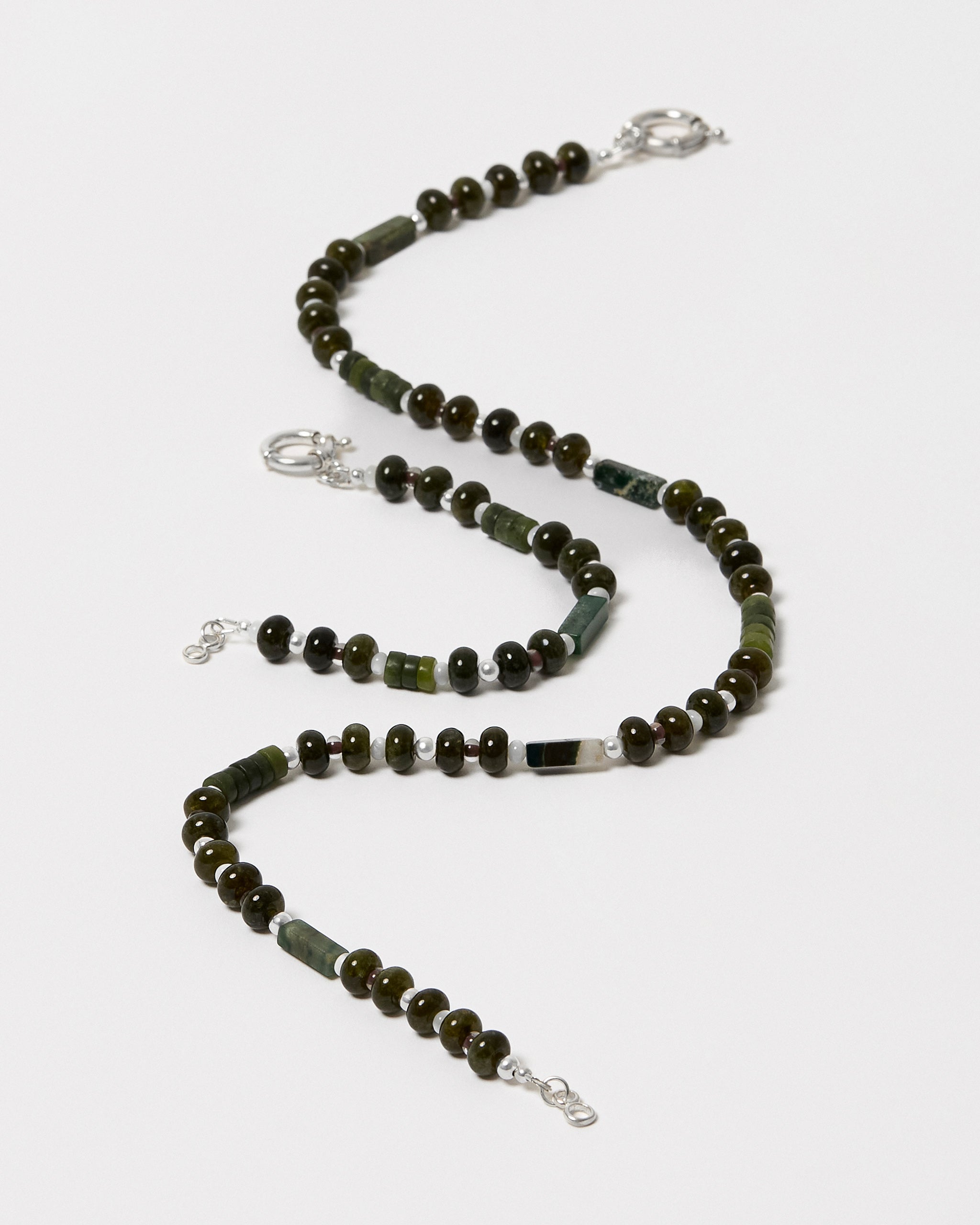 Necklace with green and brown beads on a white background