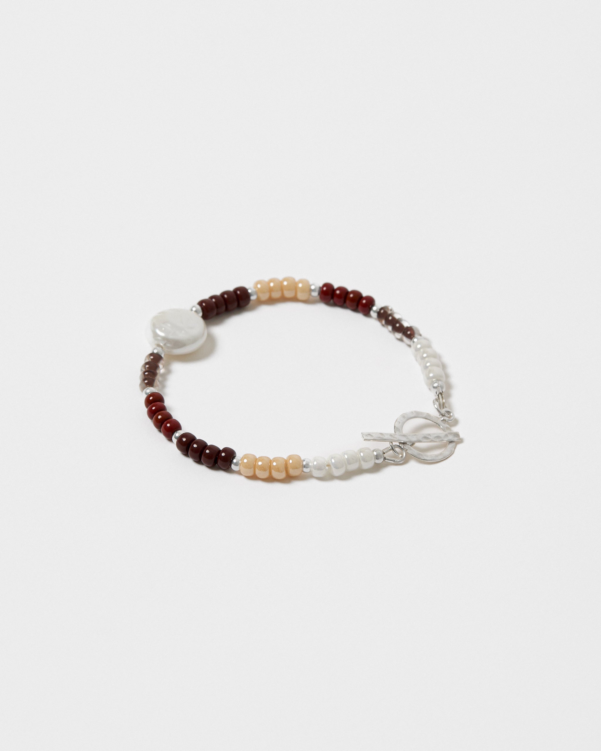 Beaded bracelet with a sterling silver clasp on a light grey background