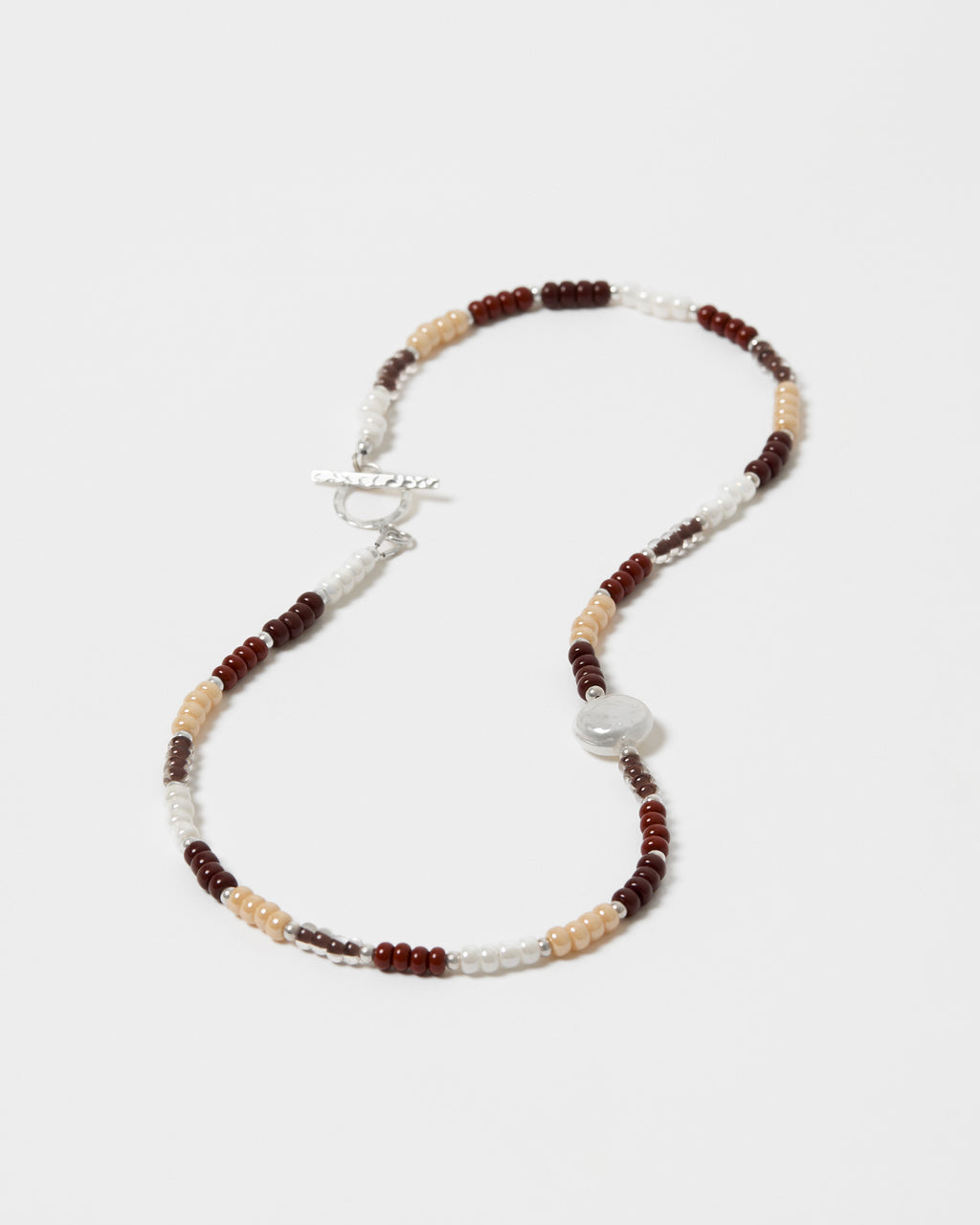 Beaded necklace with brown, beige, and white beads on a white background