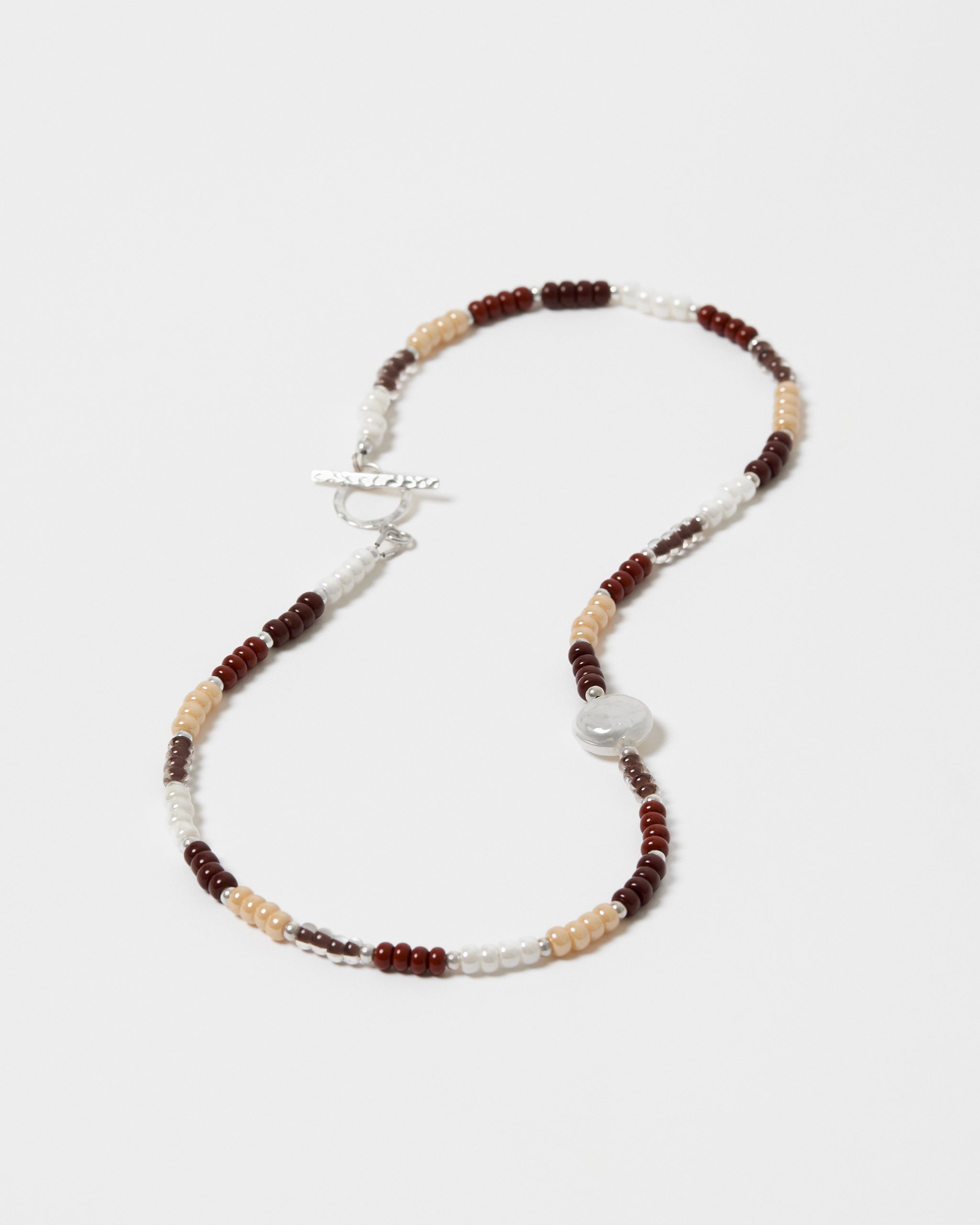 Beaded necklace with brown, beige, and white beads on a white background
