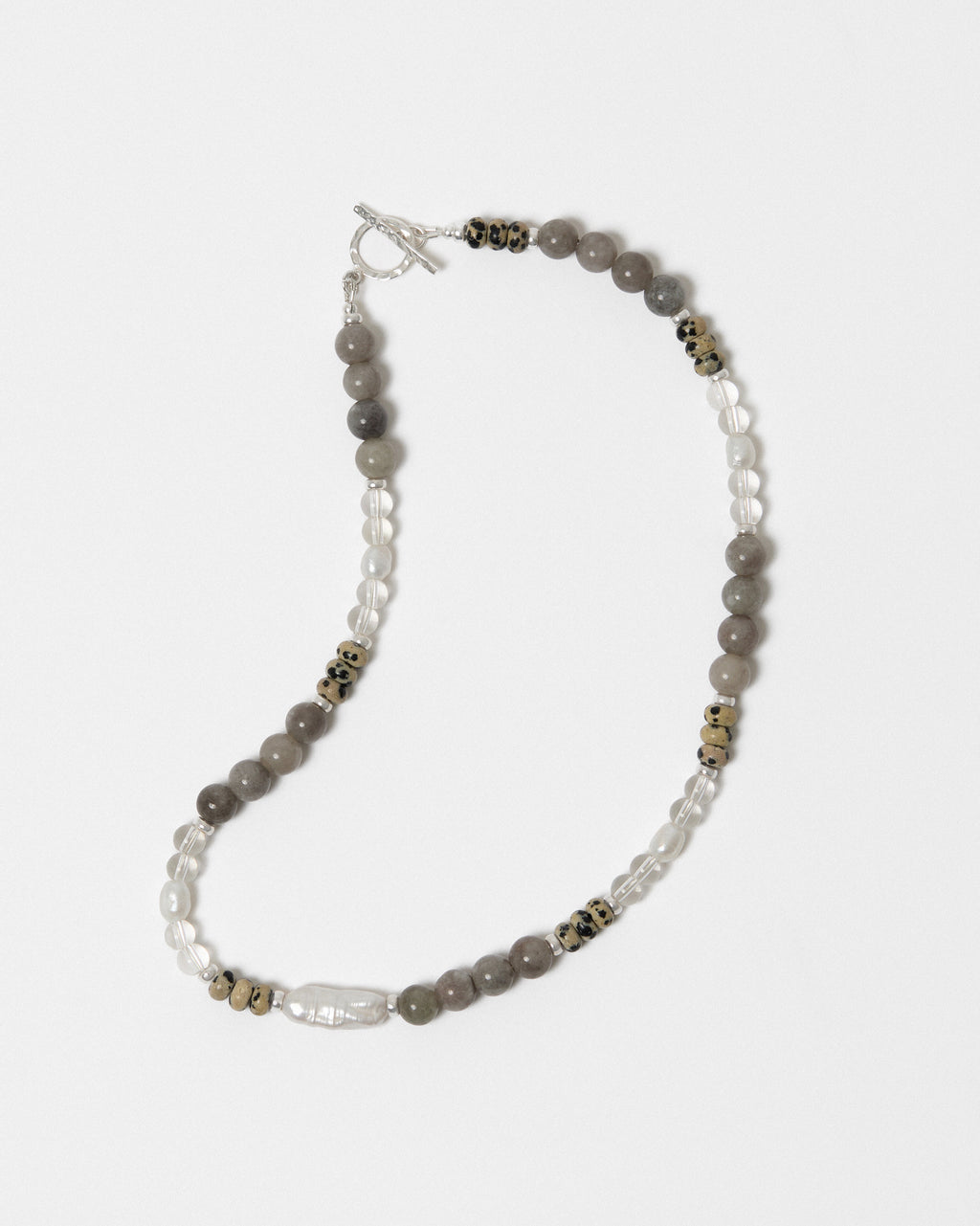 Beaded necklace with gray and white stones on a white background