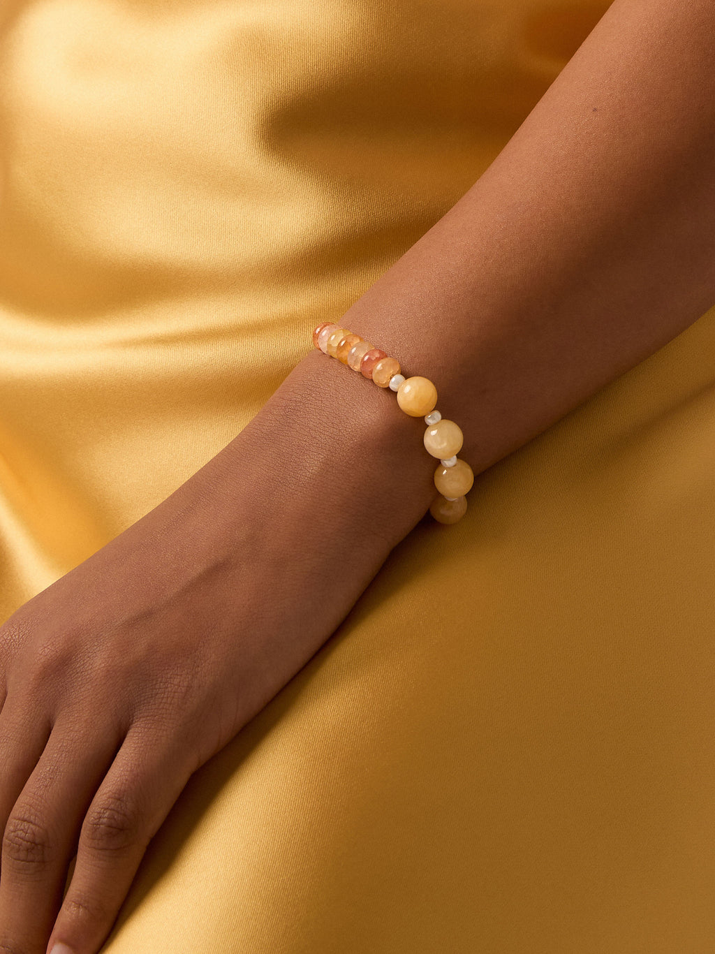 Yellow and orange beaded sterling silver bracelet on a model