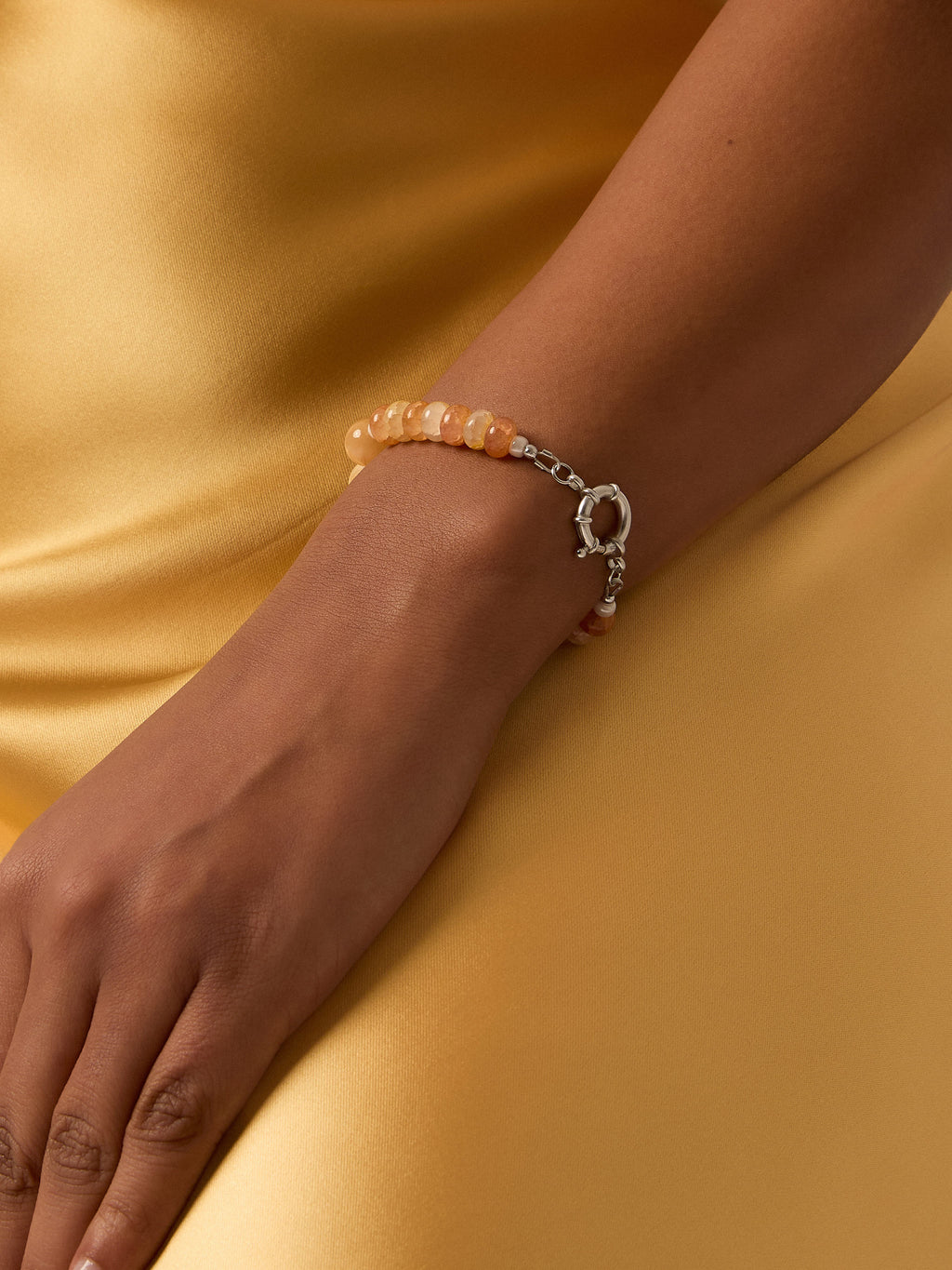 Yellow and orange beaded sterling silver bracelet on a model