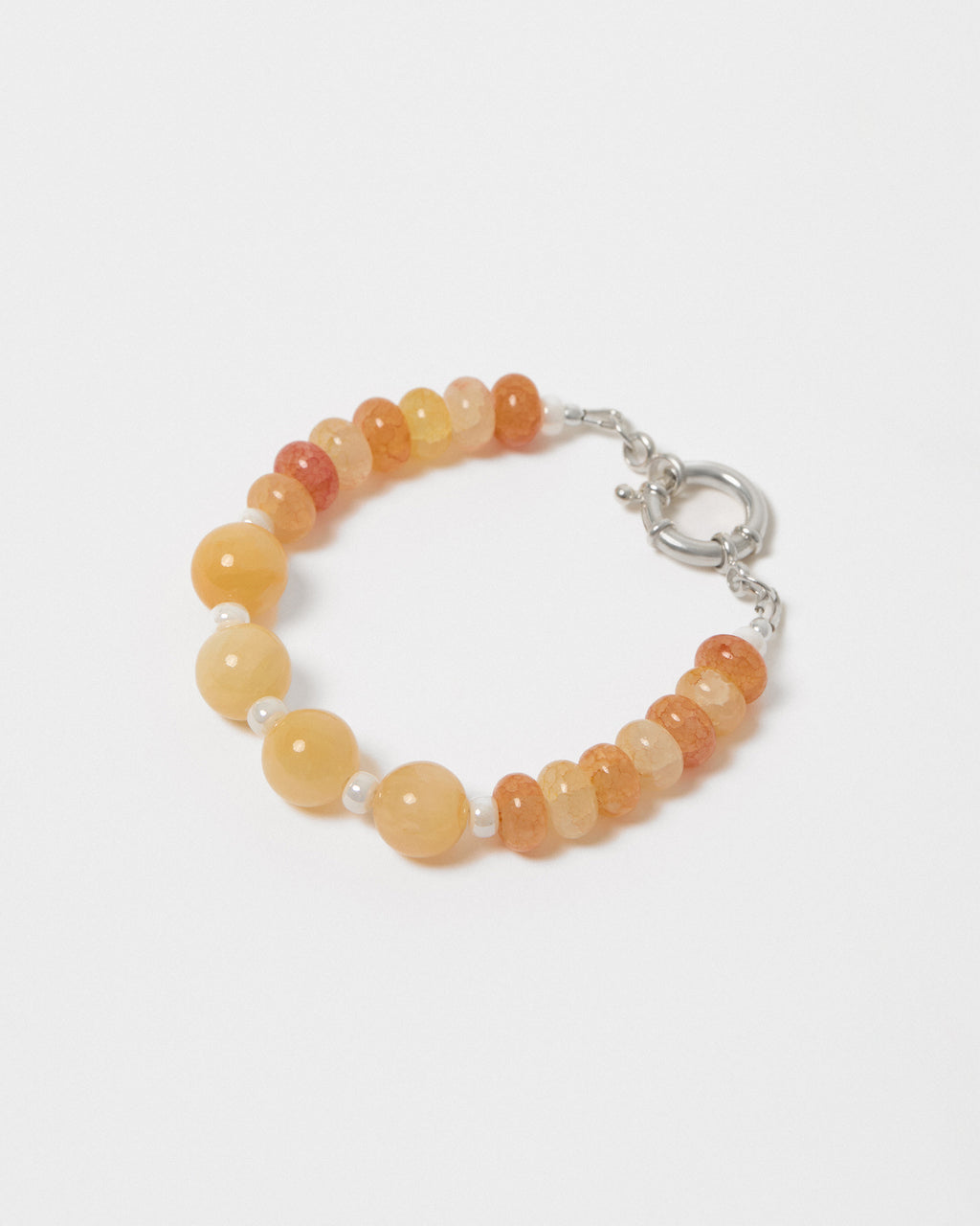 Beaded bracelet with orange and yellow beads on a white background