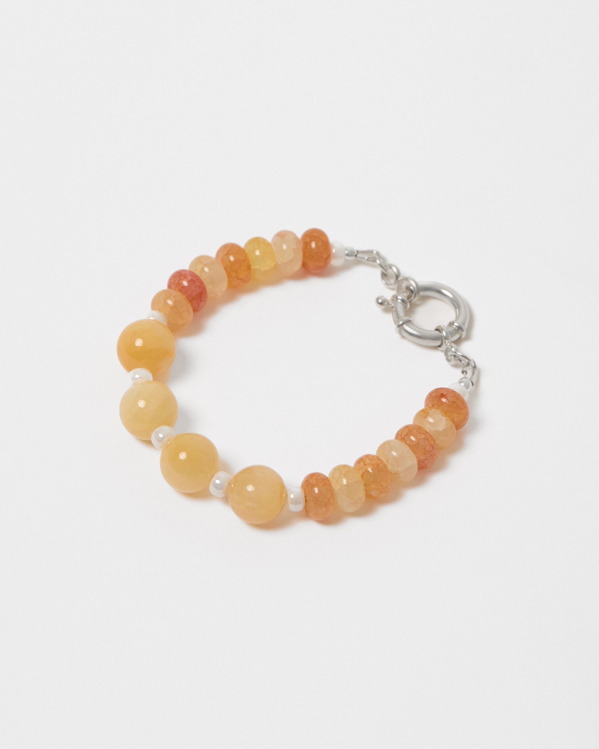 Beaded bracelet with orange and yellow beads on a white background