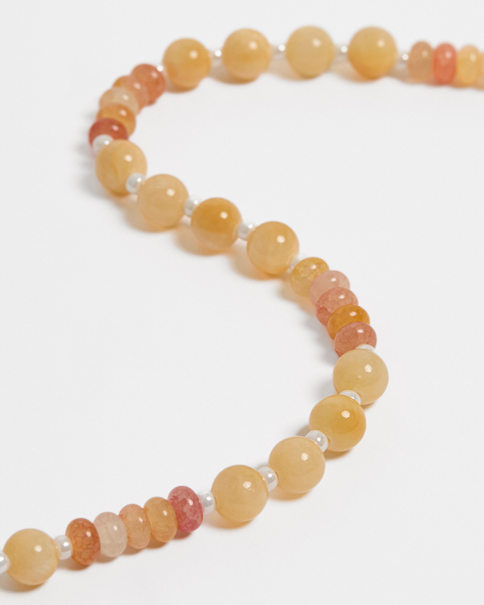 Necklace with multicoloured beads on a white background