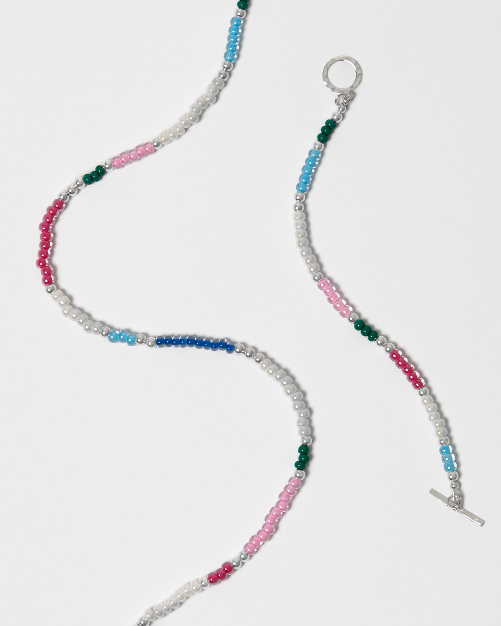 Beaded jewellery with multicolour beads on a white background